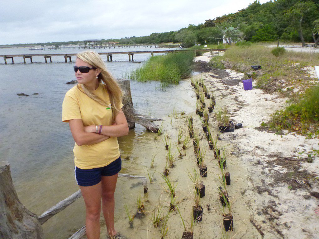 An AmeriCorps volunteer waits for students on Choctawhatchee Bay. They will be planting Spartina alterniflora as part of the Grasses in Classes Program.