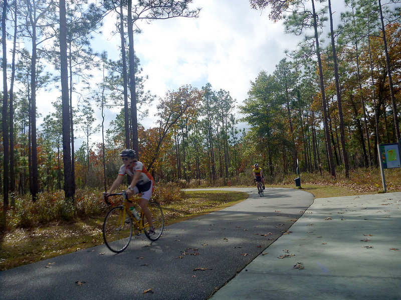 Cyclists round the bend at the Trout Pond Trailhead. They regard the two mile trail, which terminates at a quiet lake with camping facilities, as a hidden treasure. Over the next decade, this will be part of a 120 mile network of multi-use trails connecting Tallahassee with the coast.