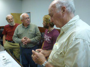 James Dunbar (center left) talks to Morgan Smith (center right). Morgan brought finds from his Wacissa excavation to the Florida Geological Survey, where Harley Means works as a geologist for the state.