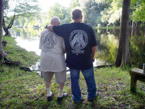 Kenneth and Teben Pyles look out over the Santa Fe River, sporting Tri-State Archeological Society t-shirts. Teben is working to one day be able to explore the river for loose artifacts.