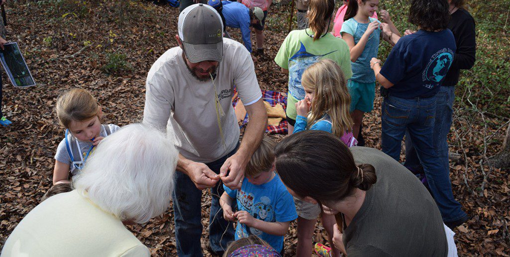 Joe Burnam teaches children to process and use yucca plant fibers to make rope at the Lost Creek Forest in Thomasville, Georgia.