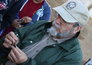Biologist David Cook tags a monarch butterfly at the St. Marks Wildlife Refuge.