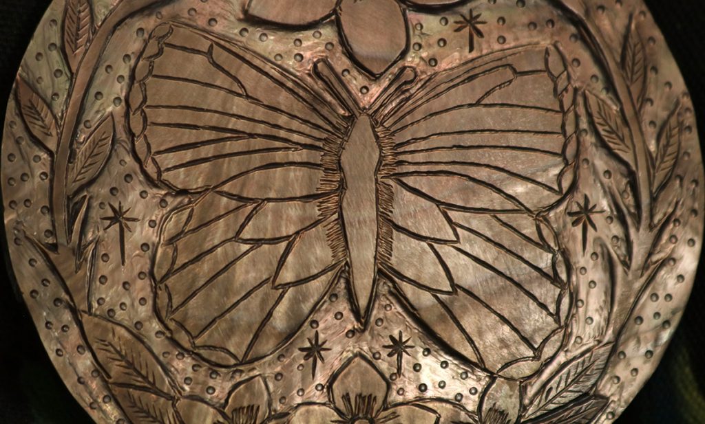 A Muscogee gorget depicting a butterfly.