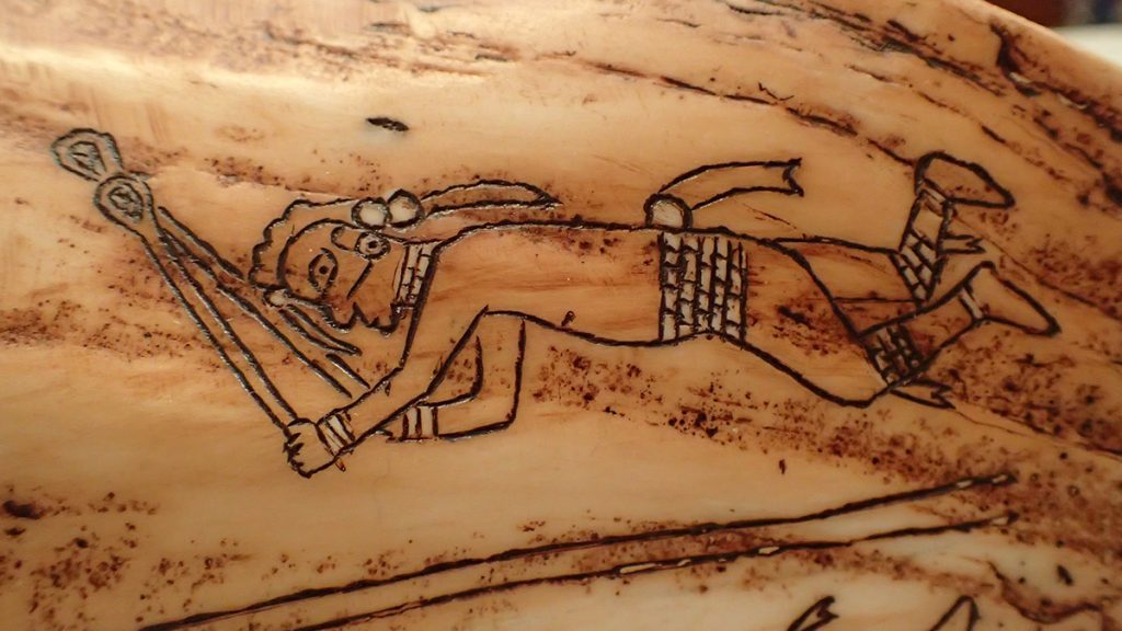 Detail of a Muscogee medicine cup, featuring a Muscogee ball player.
