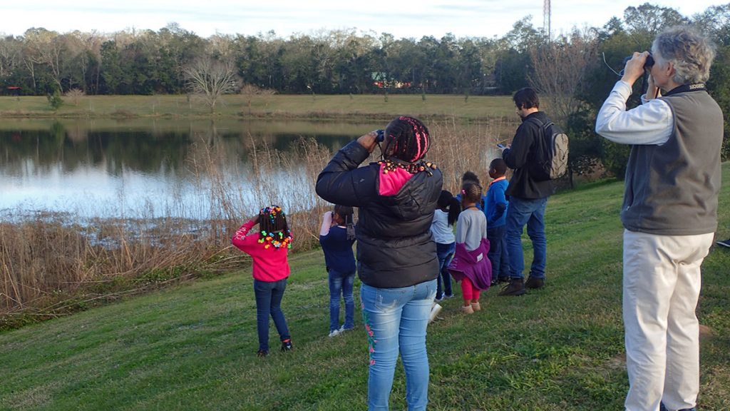 A youth group from the Walker Ford Community Center goes bird watching with Apalachee Audubon at Lake Elberta.