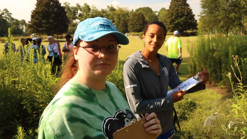 Thomas University students Megan Phillips and Alisha Clayton record observations at the Cherokee Lake Pollinator Garden.