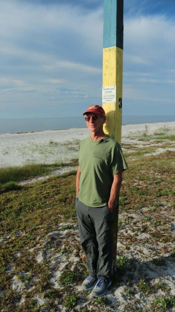Dr. Jeff Chanton stands by a post marking the height of Hurricane Dennis' storm surge.