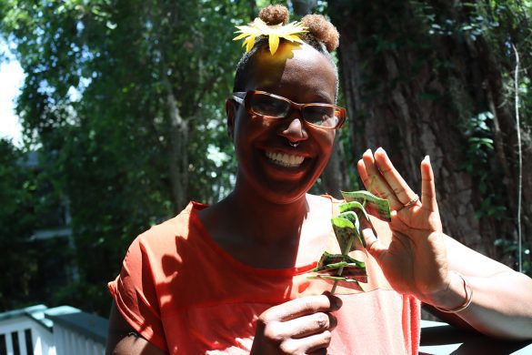 Chris Omni holds up snake plant cuttings held together by a skewer.