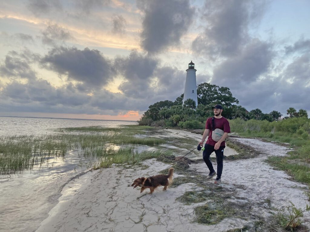 Dog walking by the Saint Marks Lighthouse